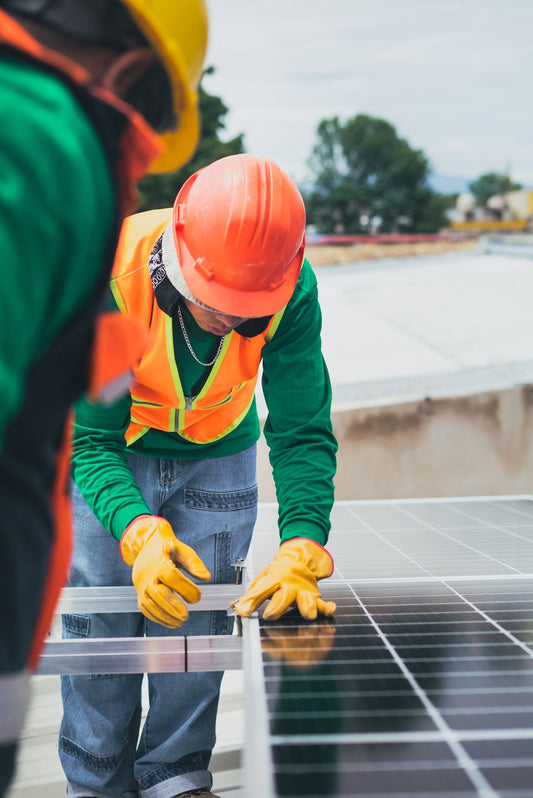 Solar technician installing a panel during field testing