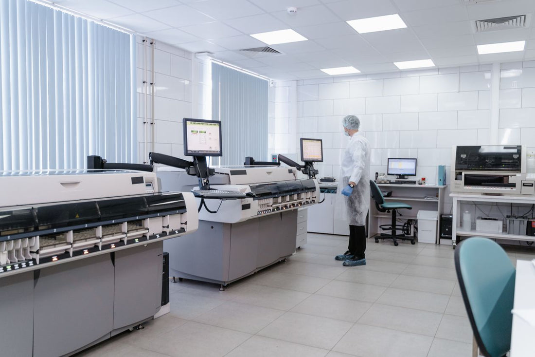 Scientist analyzing data on laboratory equipment monitors