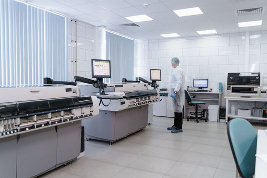Scientist analyzing data on laboratory equipment monitors
